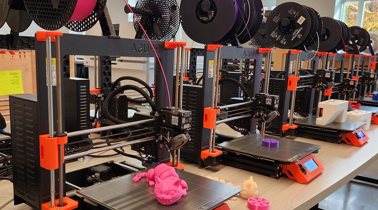 3d printers with printouts in bright colors on a table